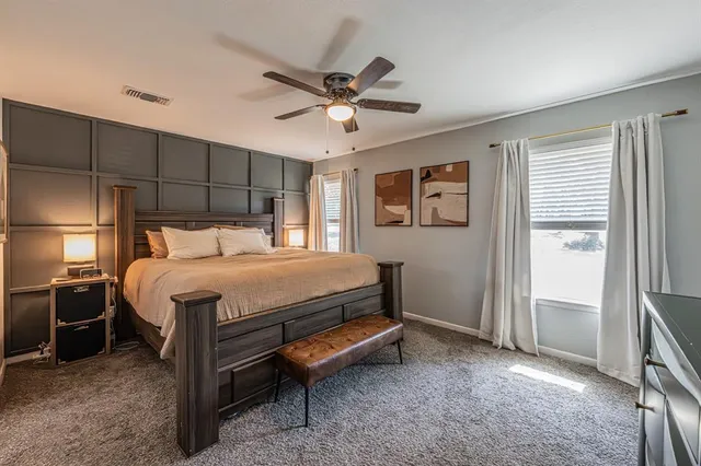 a bedroom with a bed and a ceiling fan