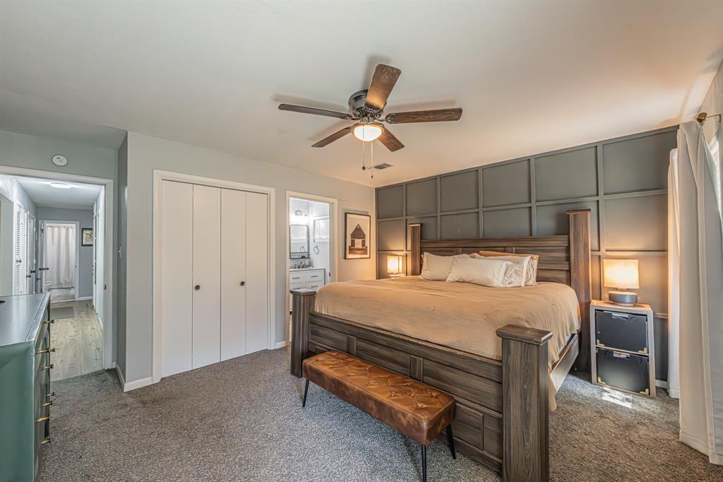 3745 Lucy Trimble Road Burleson, TX 76028 - Photo 19 of 40 a bedroom with a bed and a chandelier