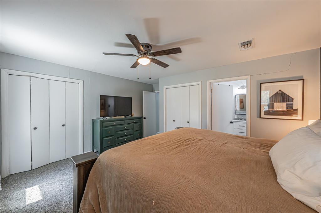 3745 Lucy Trimble Road Burleson, TX 76028 - Photo 20 of 40 a bedroom with a large bed a flat tv screen and dresser