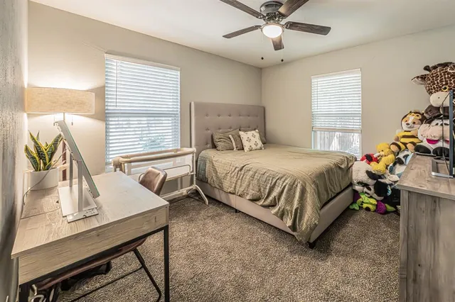 a bedroom with a bed window and table