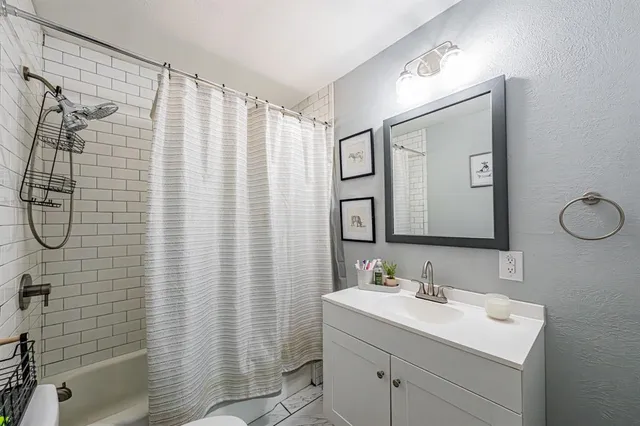a bathroom with a sink toilet and shower