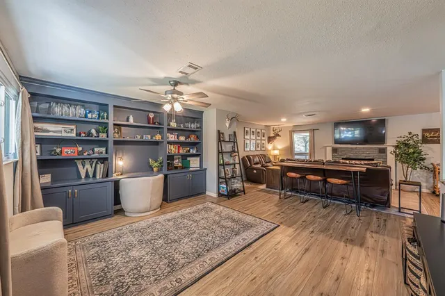 a living room with furniture and a wooden floor
