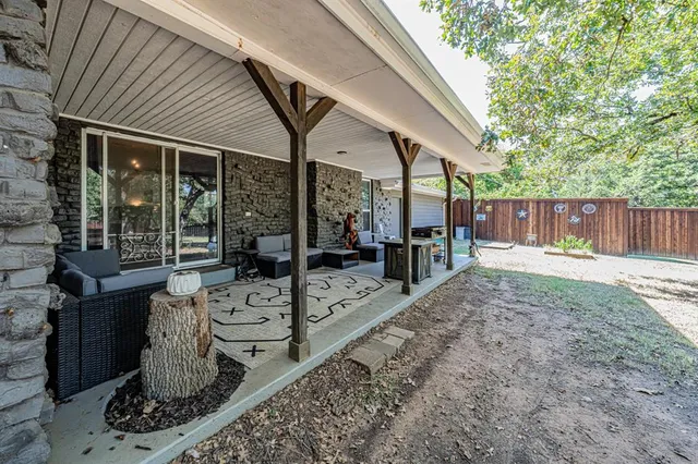 a view of a porch with furniture and garden