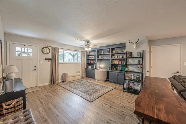 a living room with furniture and wooden floor