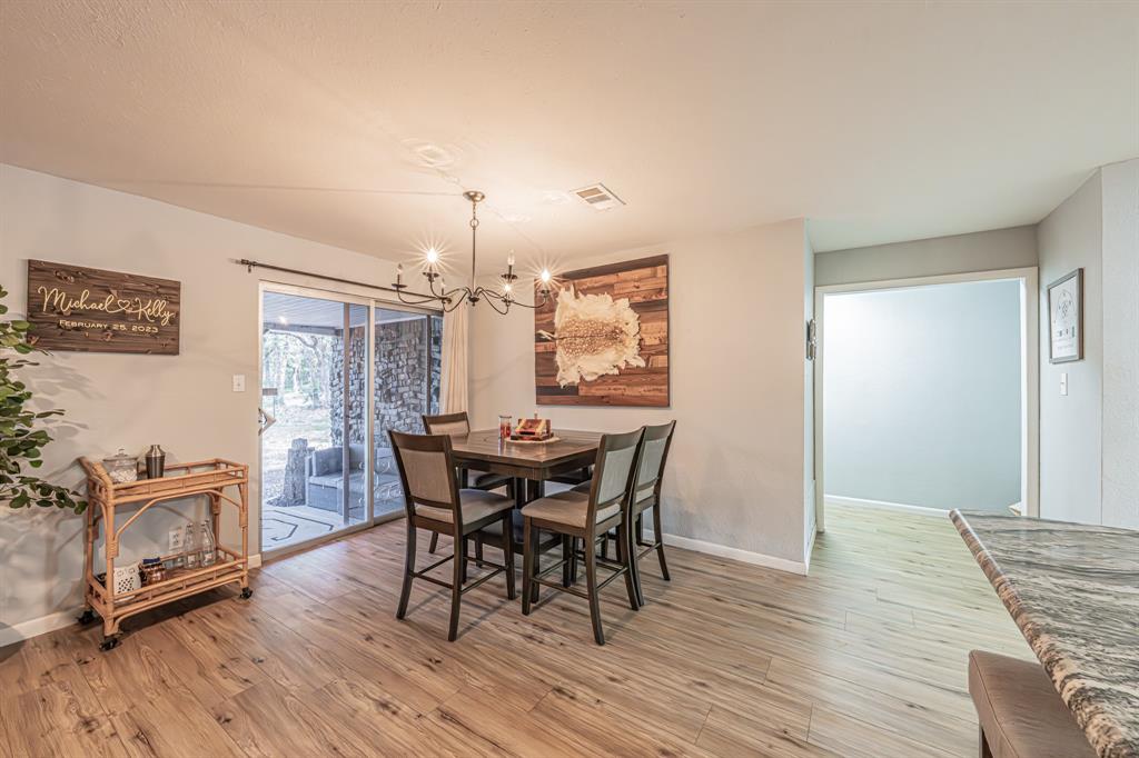 3745 Lucy Trimble Road Burleson, TX 76028 - Photo 8 of 40 a view of a dining room with furniture and wooden floor