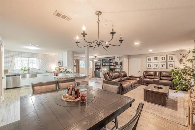a living room with lots of furniture and kitchen view
