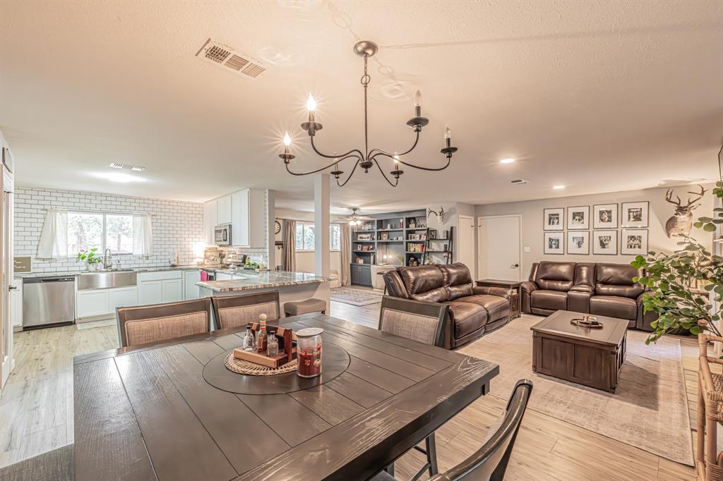 3745 Lucy Trimble Road Burleson, TX 76028 - Photo 10 of 40 a living room with lots of furniture and kitchen view