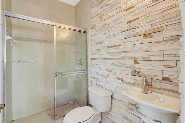 a bathroom with a sink toilet and shower