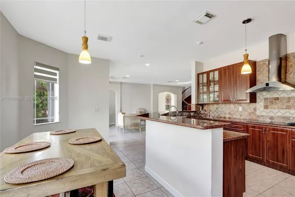 a kitchen with stainless steel appliances granite countertop a sink and a stove