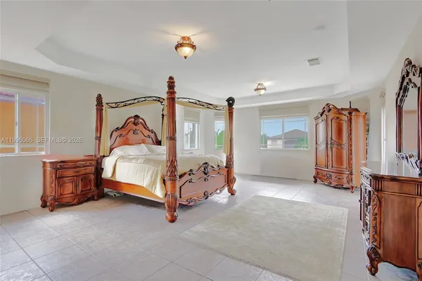 a bedroom with furniture and natural light