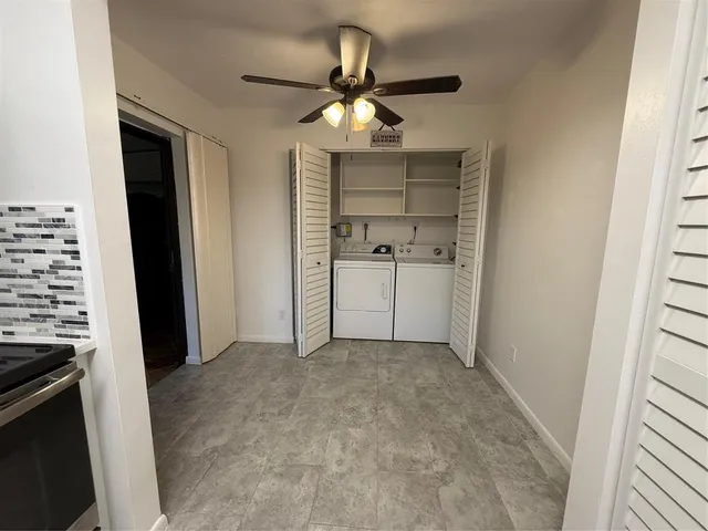 a very nice looking hallway with a kitchen