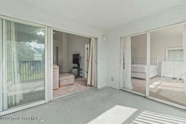 a bedroom with a bed and glass door