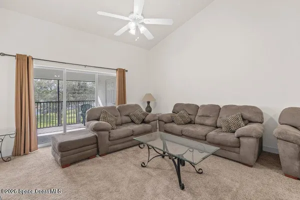 a living room with furniture and a large window