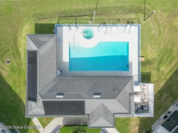 an aerial view of a house with a yard and a fountain