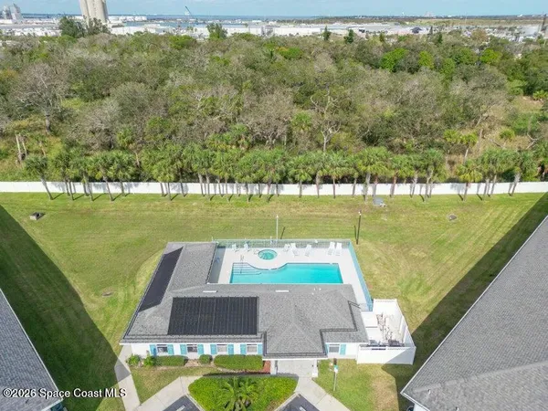 a view of a swimming pool with a yard