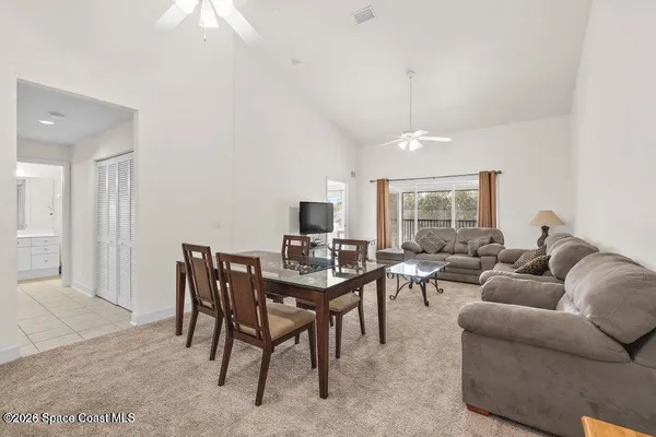 a living room with furniture a table and a flat screen tv
