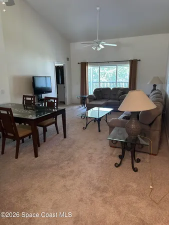 a view of a livingroom with workspace and a window
