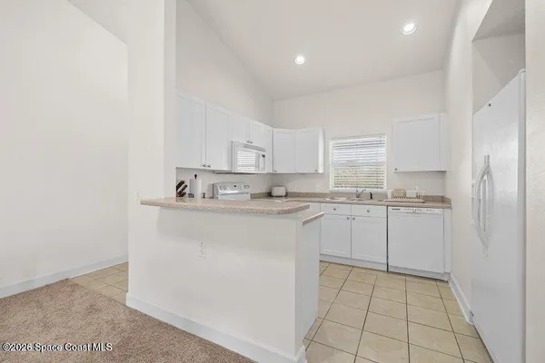 a kitchen with white cabinets