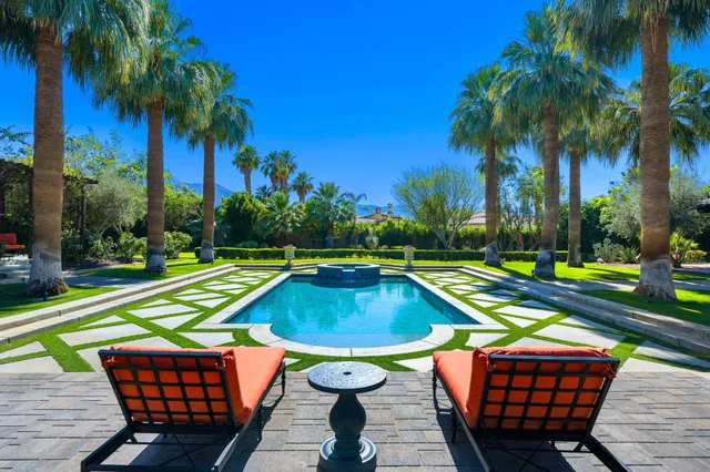 a view of a patio with table and chairs and a big yard