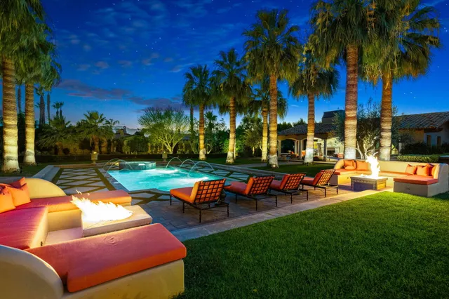 a view of a house with swimming pool and a yard