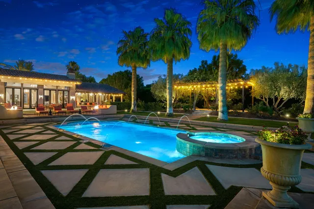 a view of swimming pool with a table and chairs