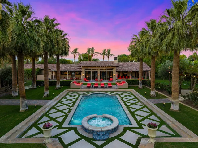a swimming pool with outdoor seating and yard