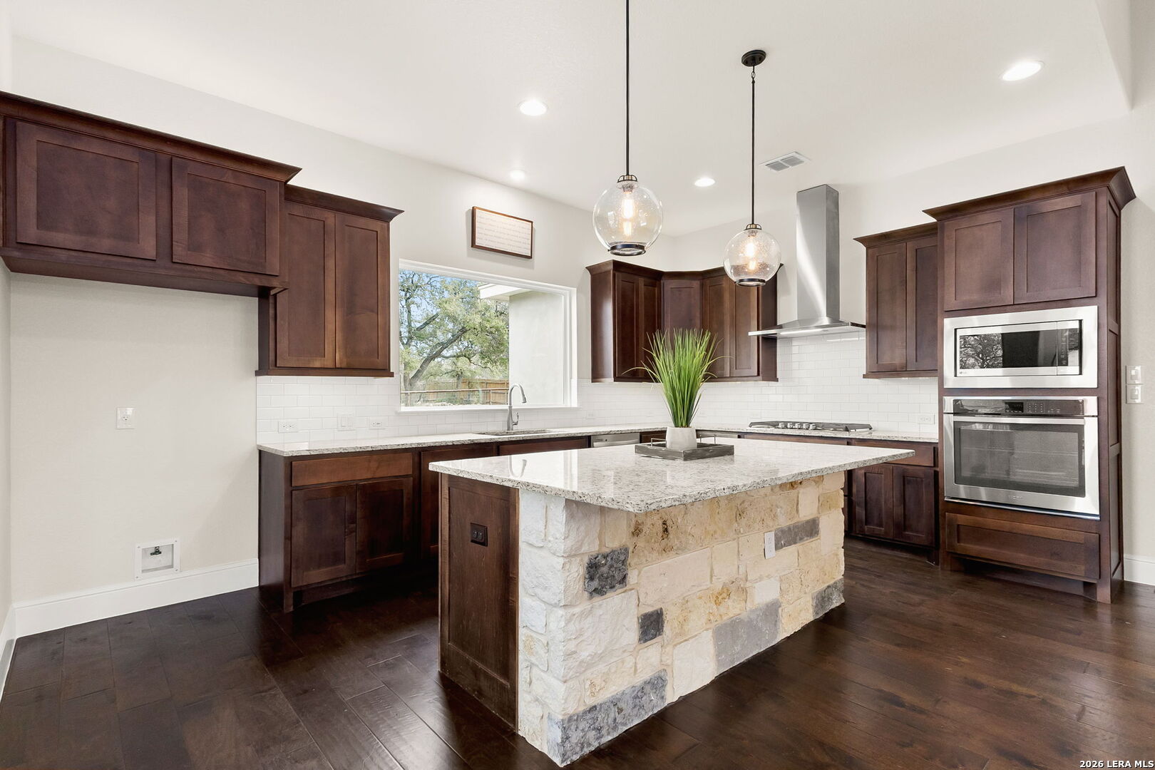 1217 Paladin Trail Spring Branch, TX 78070 - Photo 11 of 53 a kitchen with stainless steel appliances granite countertop a sink a stove and a refrigerator