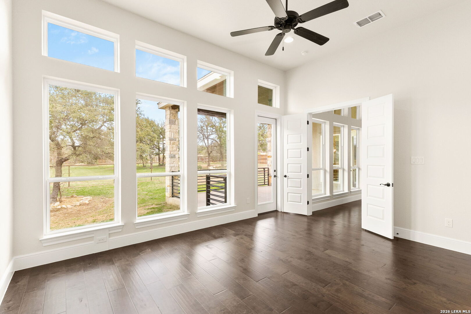1217 Paladin Trail Spring Branch, TX 78070 - Photo 13 of 53 a view of an empty room with a window and wooden floor