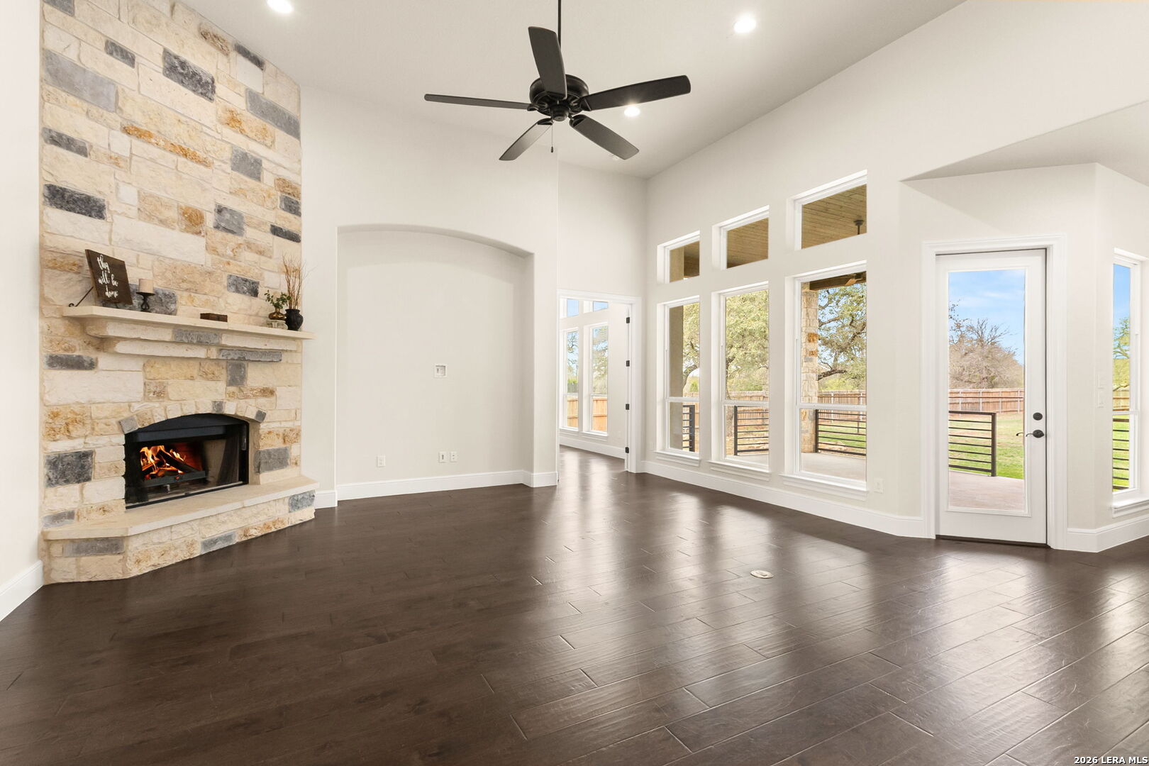 1217 Paladin Trail Spring Branch, TX 78070 - Photo 4 of 53 a view of an empty room with wooden floor fireplace and a window