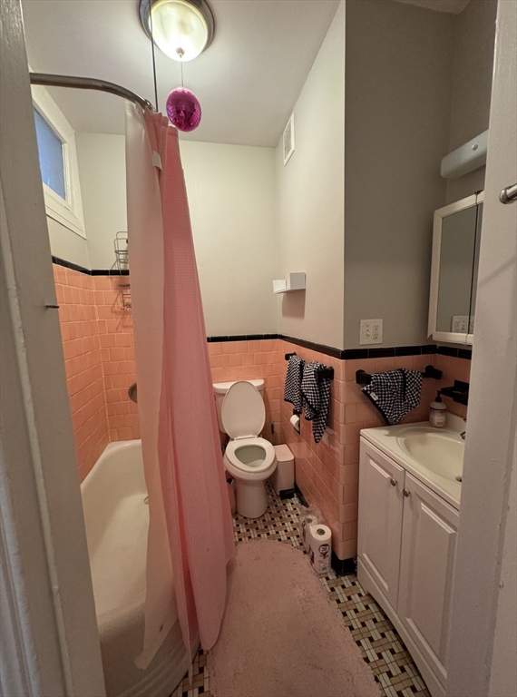 9 Sewall Avenue, Unit 314 Brookline, MA 02446 - Photo 7 of 12 a bathroom with a sink mirror vanity and toilet