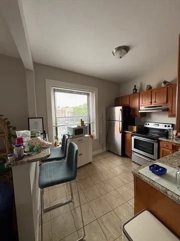 a kitchen with stainless steel appliances granite countertop a stove top oven a sink and dishwasher