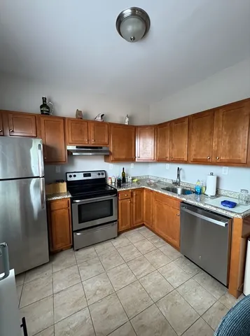 a kitchen with a table chairs and flat screen tv