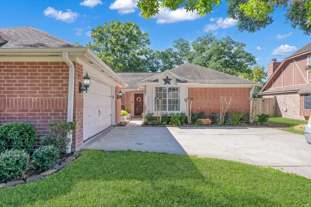 a view of a brick house with a yard