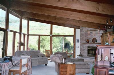 1000 Riverside Drive Ukiah, CA 95482 - Photo 5 of 12 a living room with furniture a fireplace and a floor to ceiling window