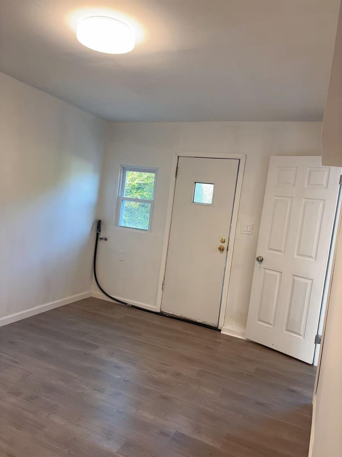 2333 Beech Street Wantagh, NY 11793 - Photo 11 of 21 Entryway with dark wood-style floors and baseboards