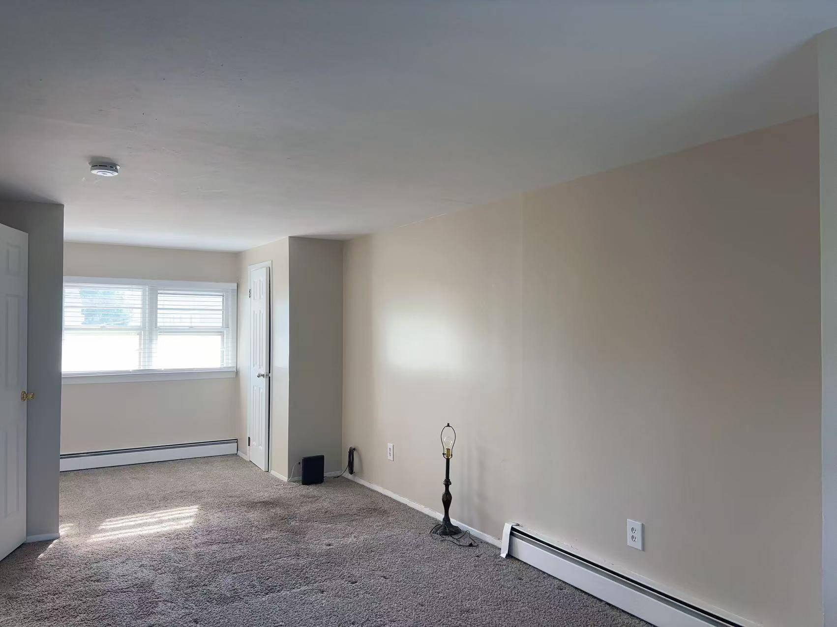 2333 Beech Street Wantagh, NY 11793 - Photo 13 of 21 Empty room with a baseboard heating unit, carpet floors, baseboards, and a smoke detector