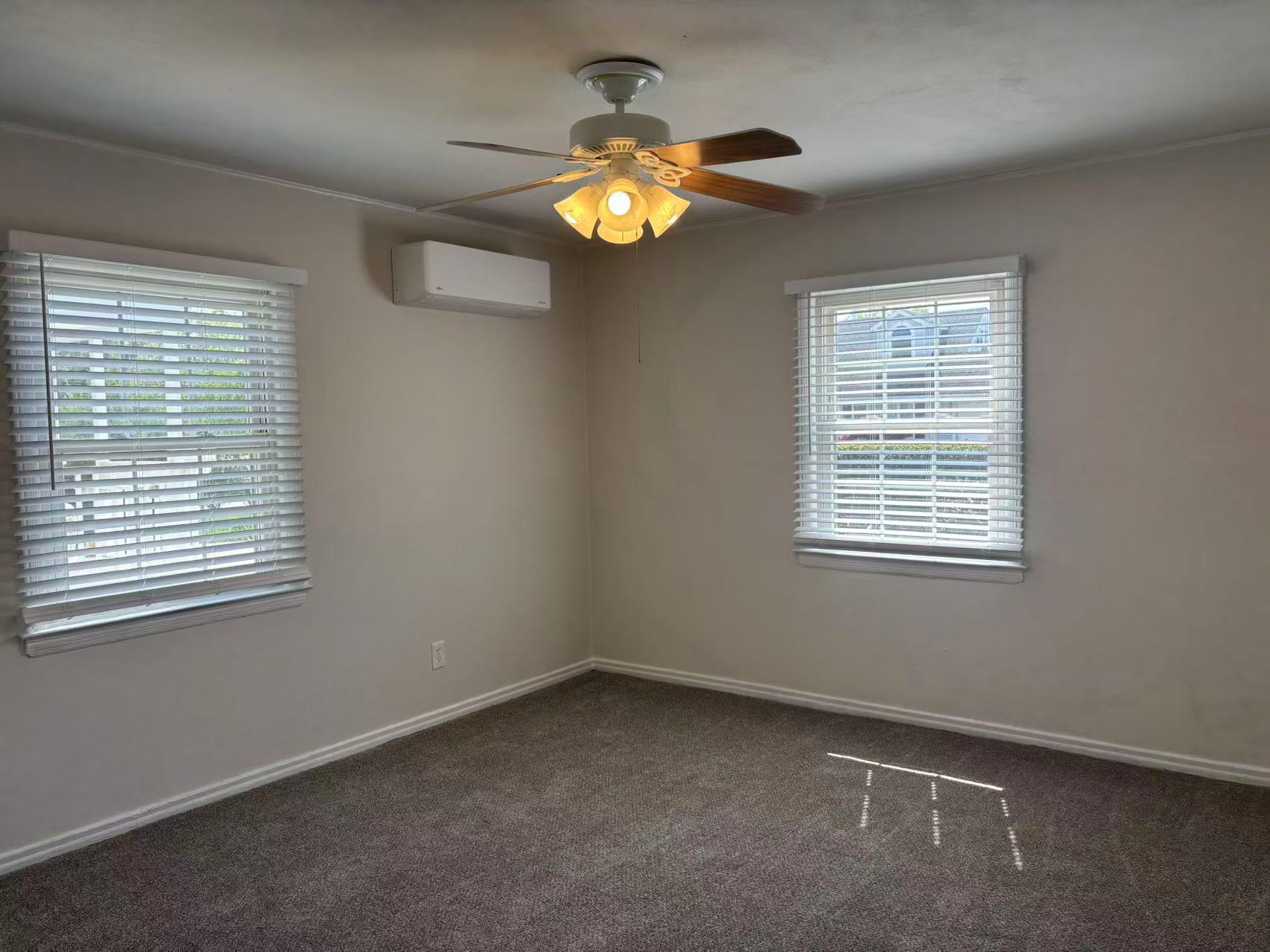 2333 Beech Street Wantagh, NY 11793 - Photo 4 of 21 Spare room featuring an AC wall unit, plenty of natural light, carpet, and ceiling fan