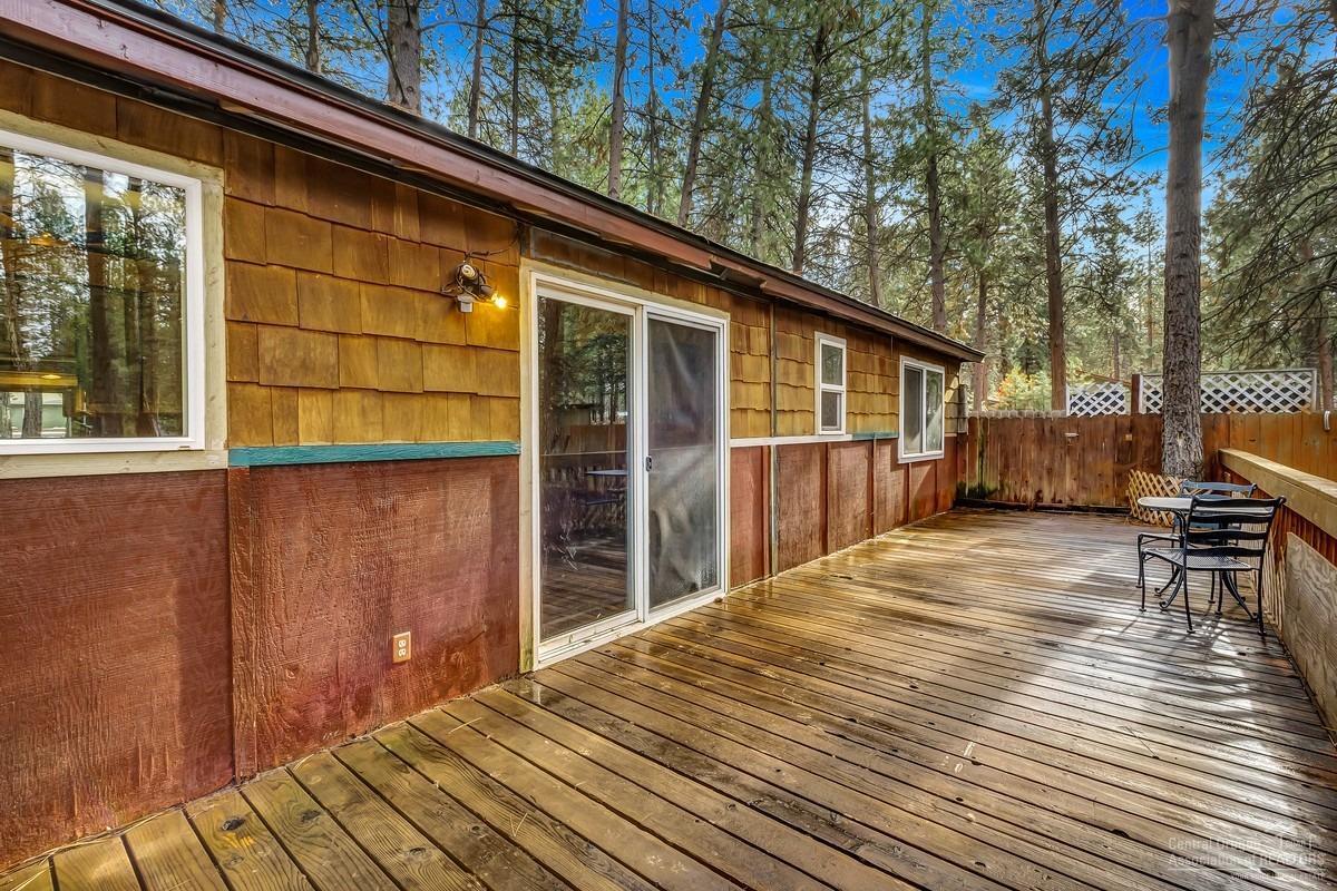 59757 Cheyenne Road Bend, OR 97702 - Photo 17 of 25 a backyard of a house with wooden floor and fence