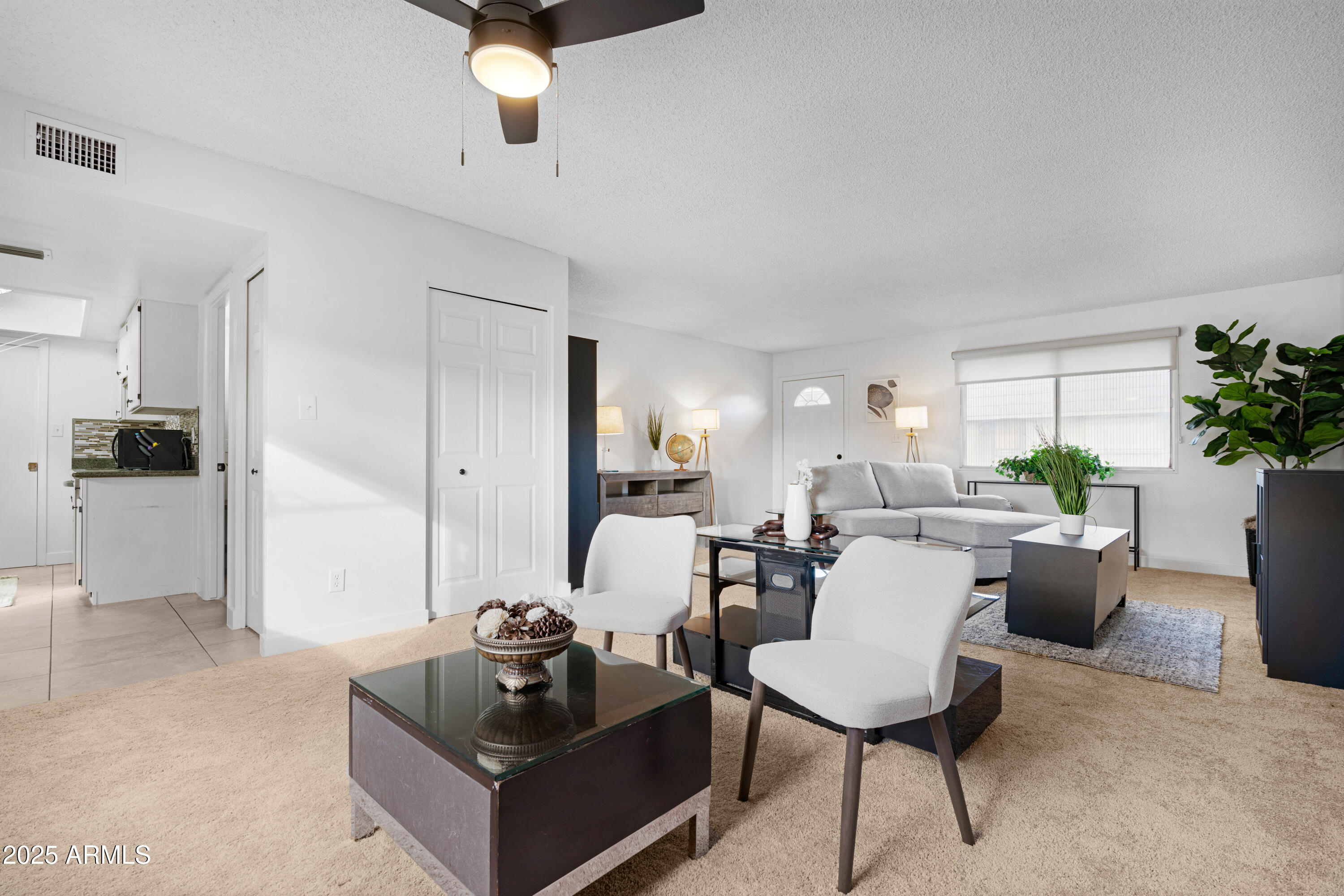 2042 West Elm Street Phoenix, AZ 85015 - Photo 12 of 35 a living room with furniture and a chandelier