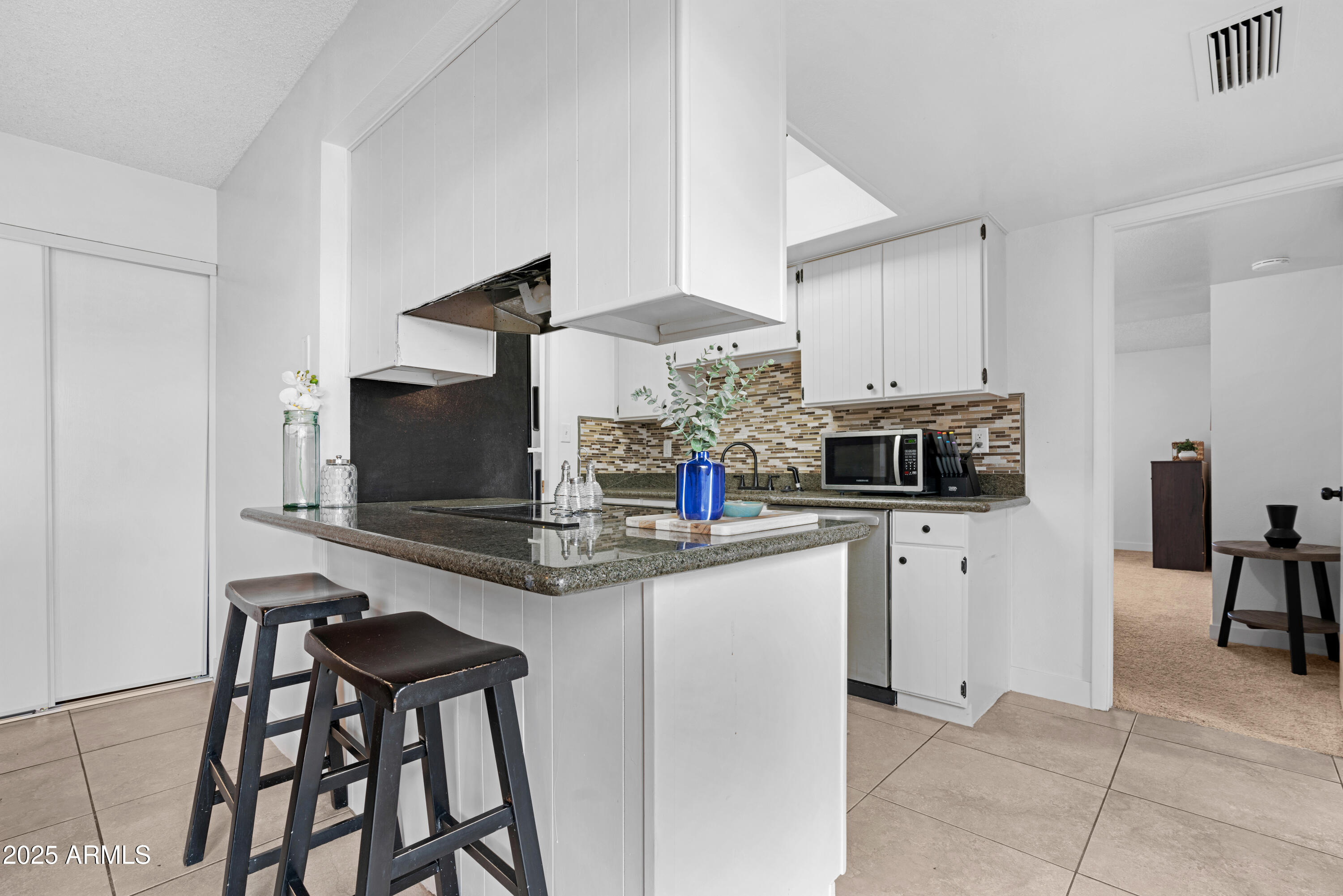 2042 West Elm Street Phoenix, AZ 85015 - Photo 13 of 35 a kitchen with stainless steel appliances a stove top oven a sink a counter top space and cabinets