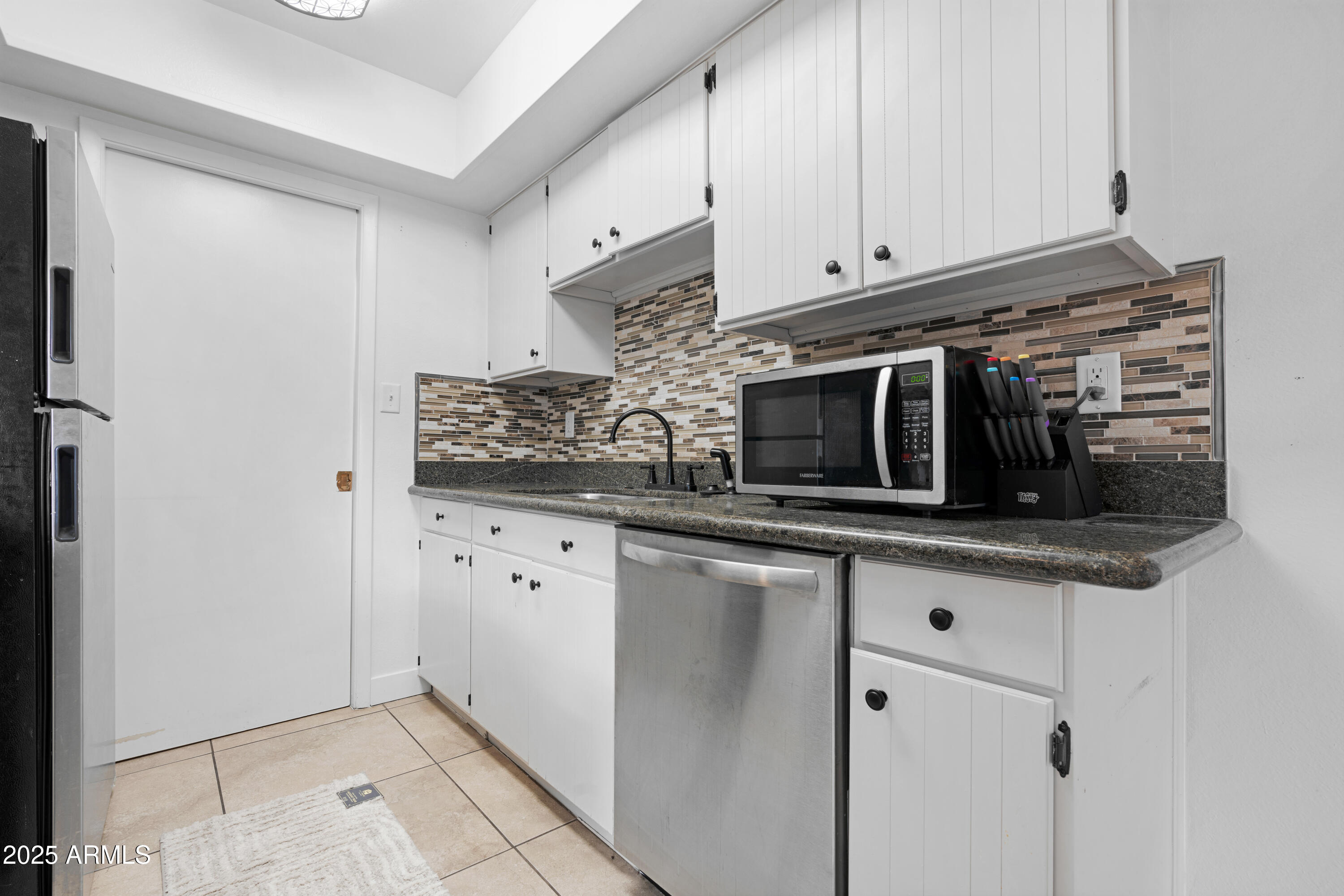2042 West Elm Street Phoenix, AZ 85015 - Photo 15 of 35 a kitchen with stainless steel appliances granite countertop a sink and a microwave