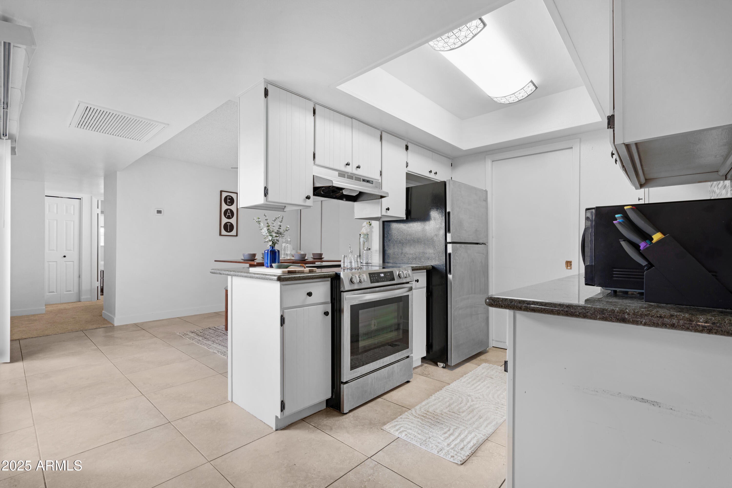 2042 West Elm Street Phoenix, AZ 85015 - Photo 16 of 35 a kitchen with stainless steel appliances granite countertop a stove a sink and a refrigerator