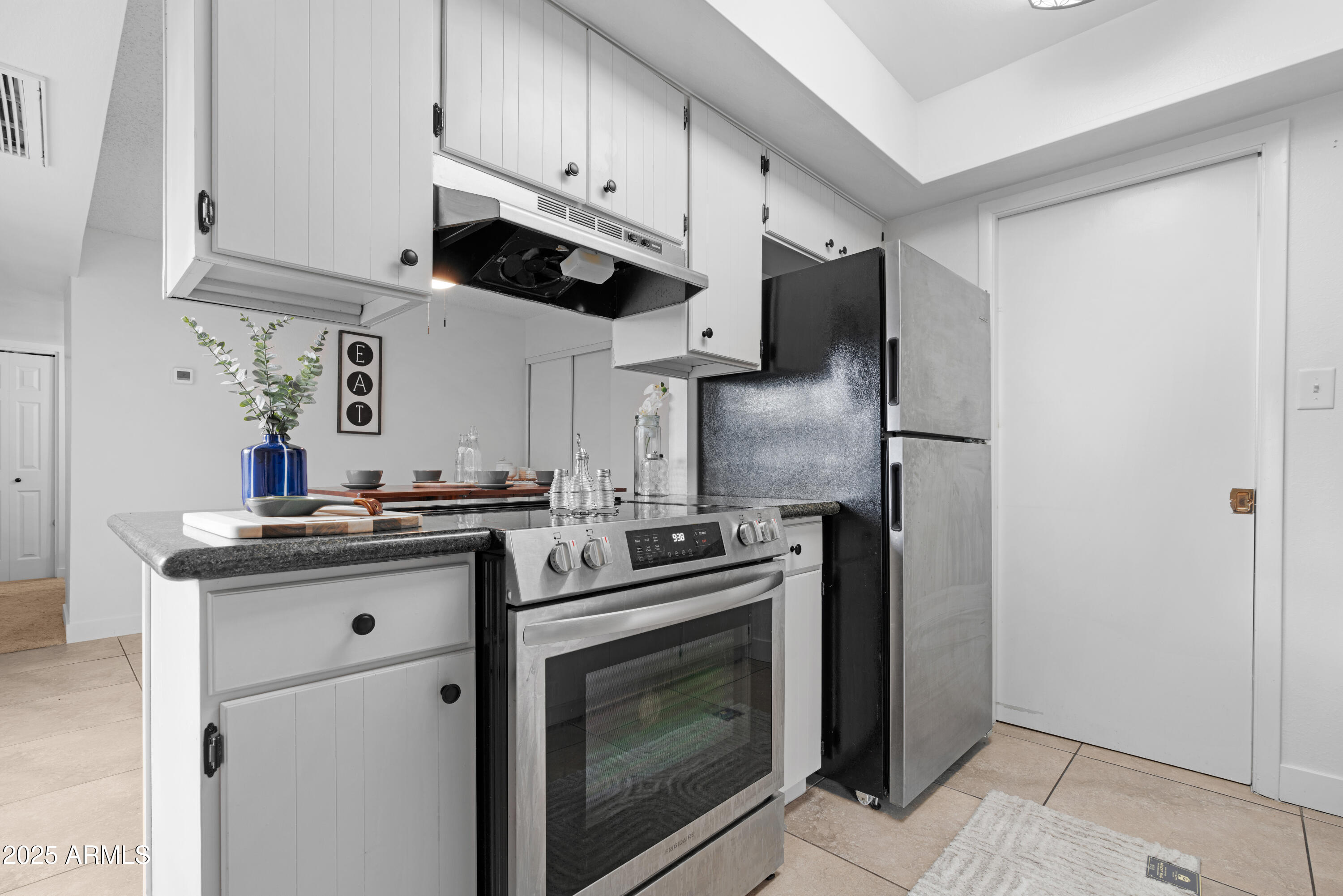 2042 West Elm Street Phoenix, AZ 85015 - Photo 17 of 35 a kitchen with stainless steel appliances a stove and a refrigerator