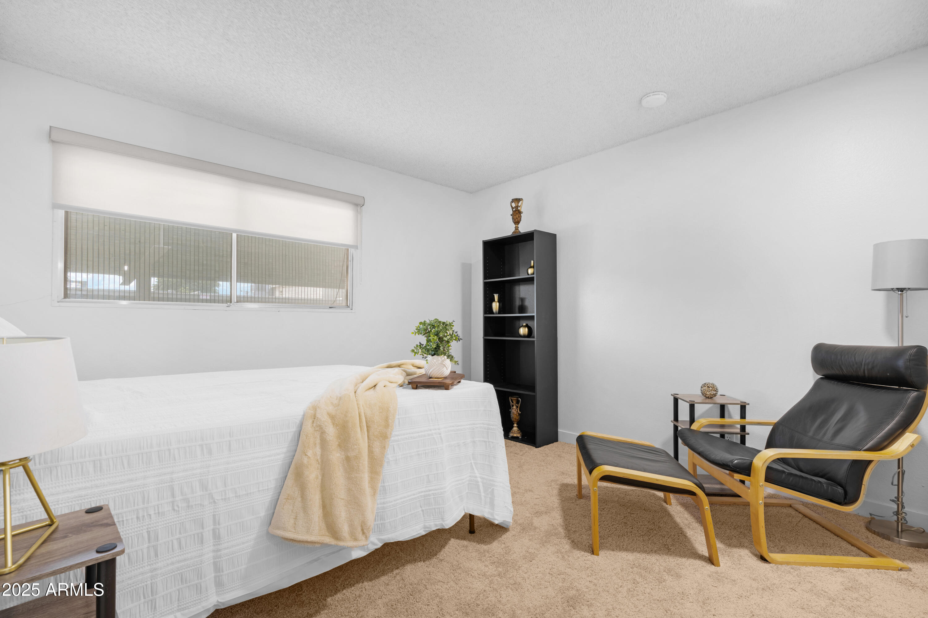 2042 West Elm Street Phoenix, AZ 85015 - Photo 26 of 35 a bedroom with a bed and a chair