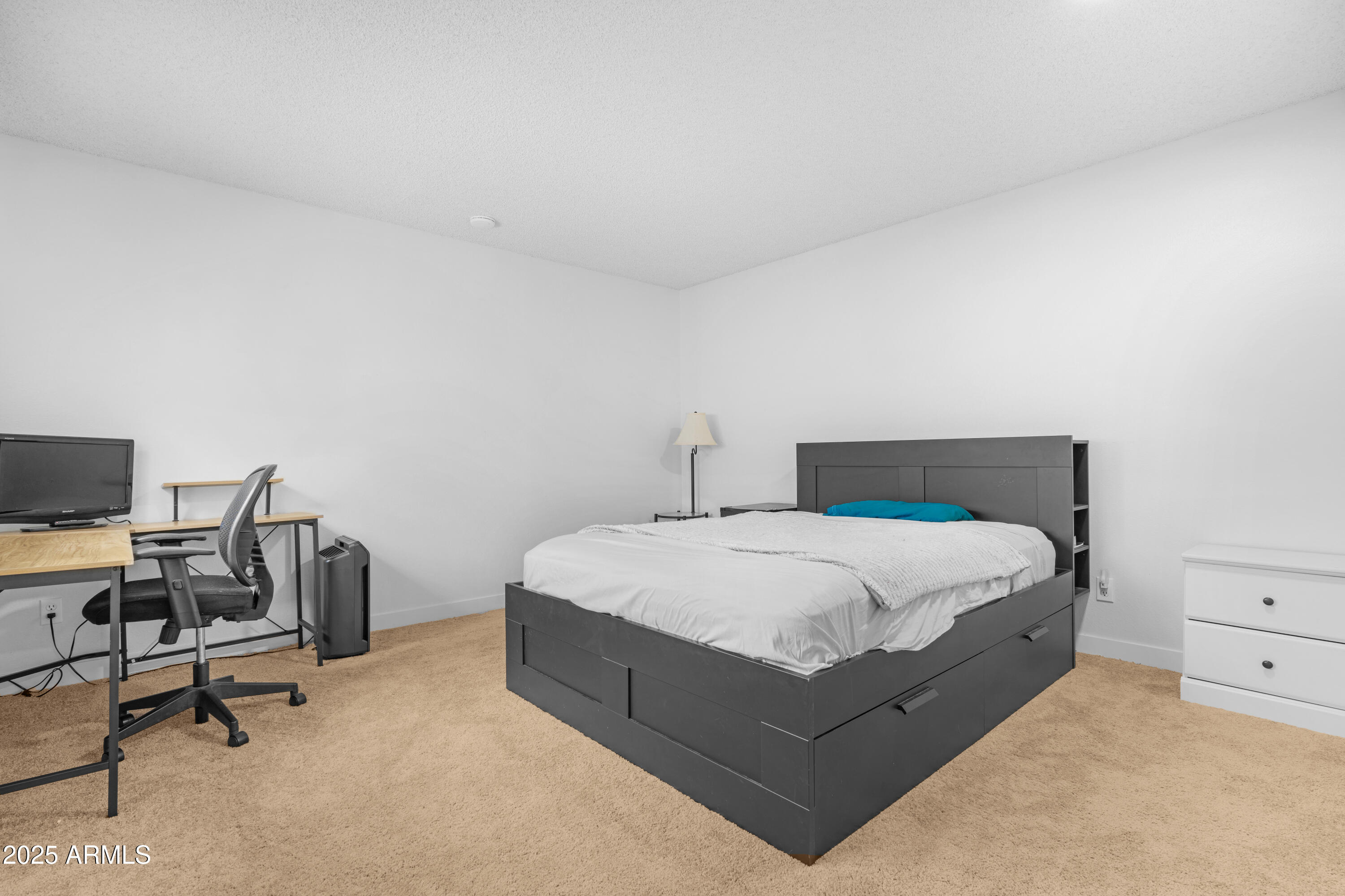 2042 West Elm Street Phoenix, AZ 85015 - Photo 29 of 35 a bedroom with a bed a desk and chair