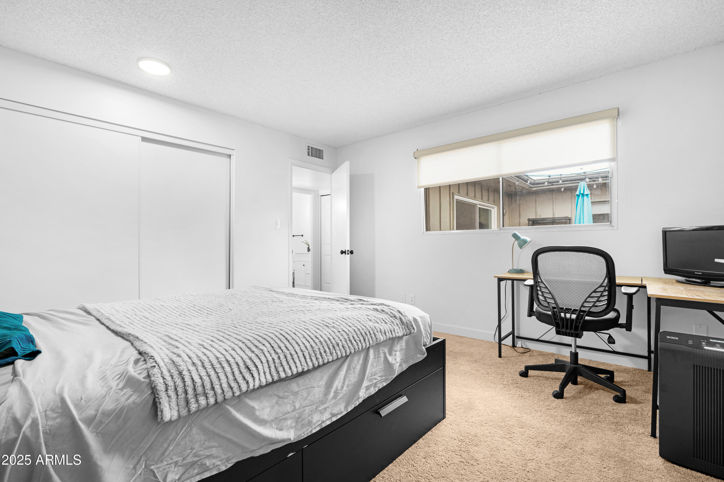 2042 West Elm Street Phoenix, AZ 85015 - Photo 30 of 35 a bedroom with a bed a table and chair