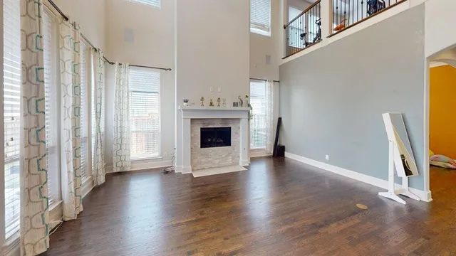 a view of a livingroom with wooden floor and a fireplace