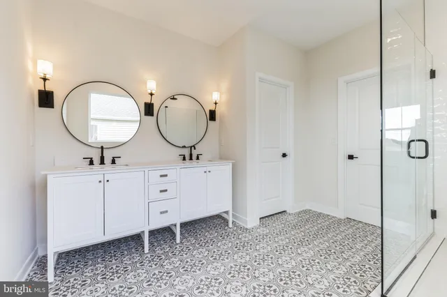 a bathroom with a sink a mirror and a shower