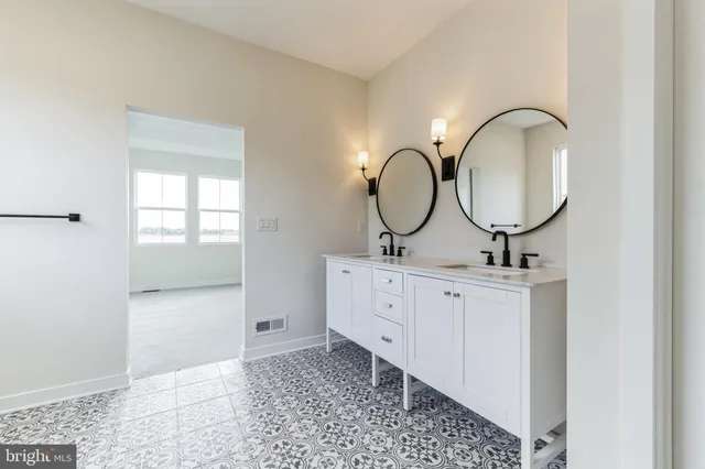 a bathroom with a double vanity sink and a mirror