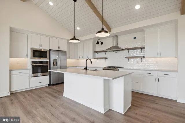 a kitchen with stainless steel appliances a sink stove and refrigerator